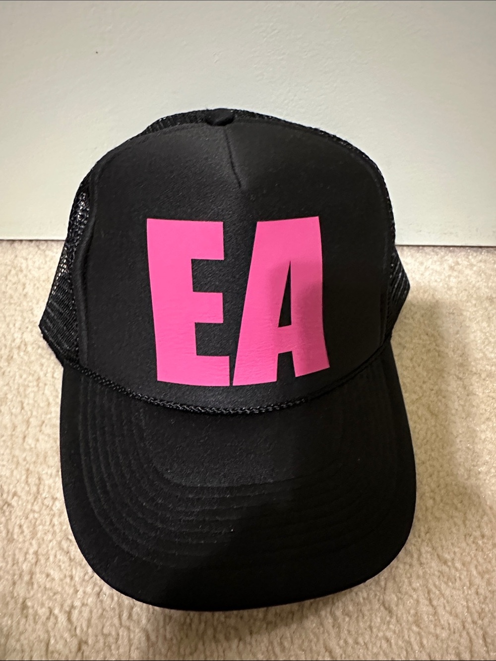 Black Trucker Hat with Bold Pink "EA" Letters
